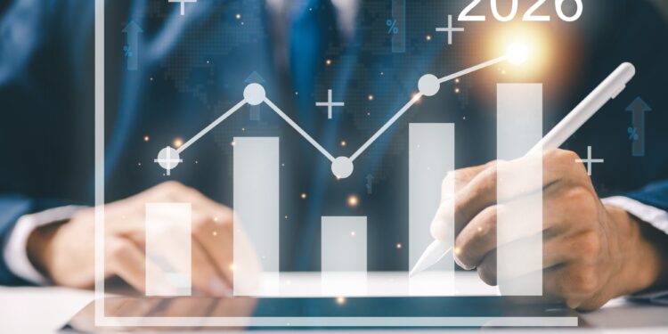 Takım elbiseli bir kişi dijital grafik üzerine dijital kalemle yazıyor.